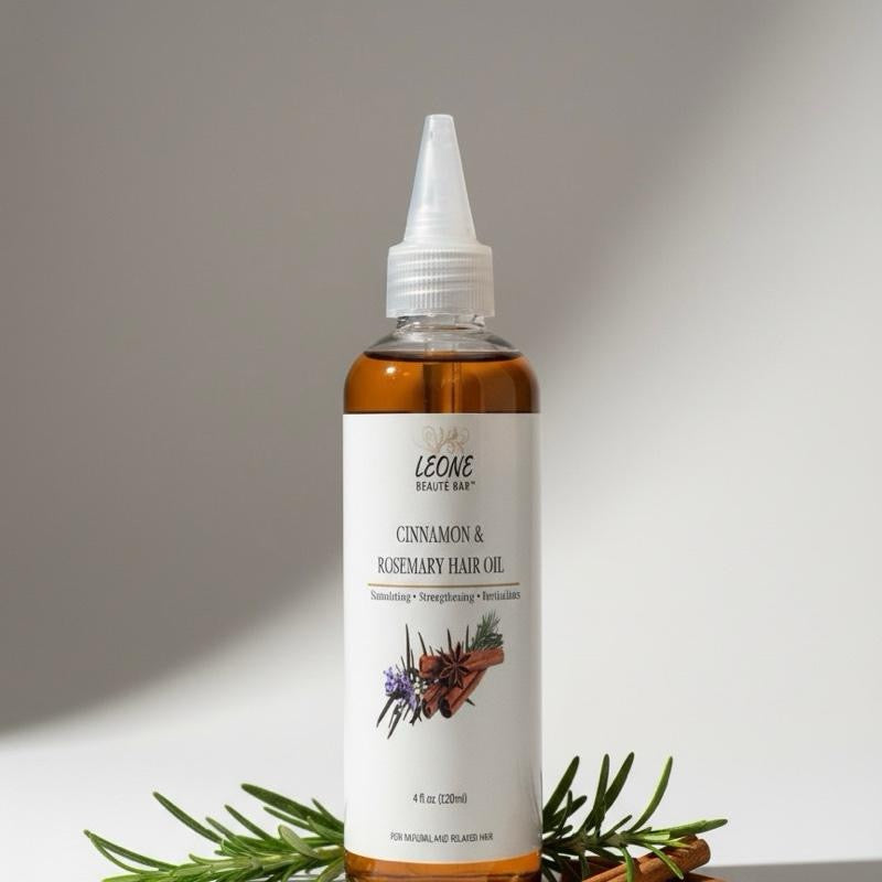 Bottle of Leone Cinnamon & Rosemary Hair Oil on a neutral background