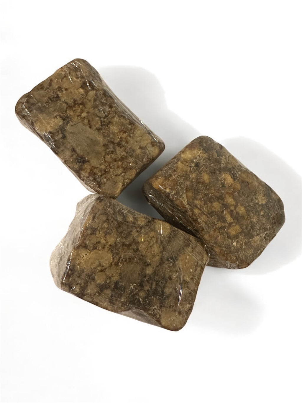 Three African black soaps on a white background