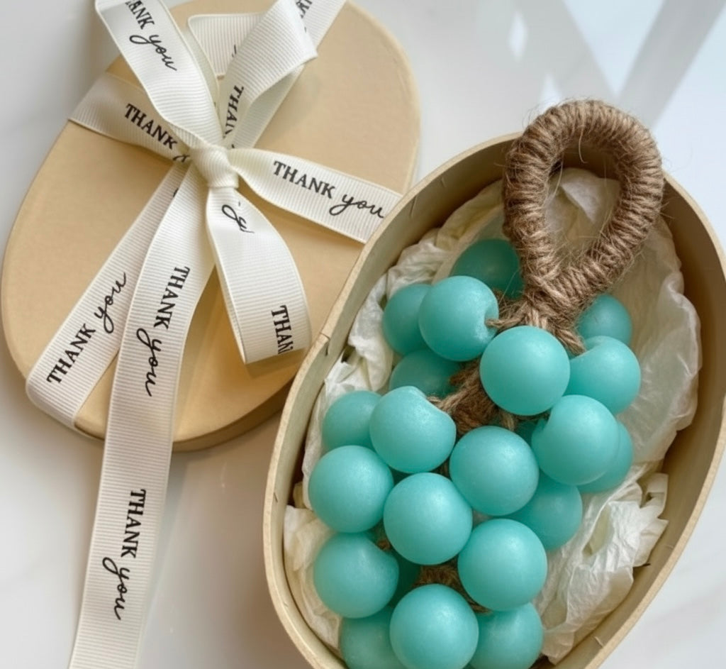Heart-shaped box with turquoise grapevine soap and a 'thank you' ribbon on a light background