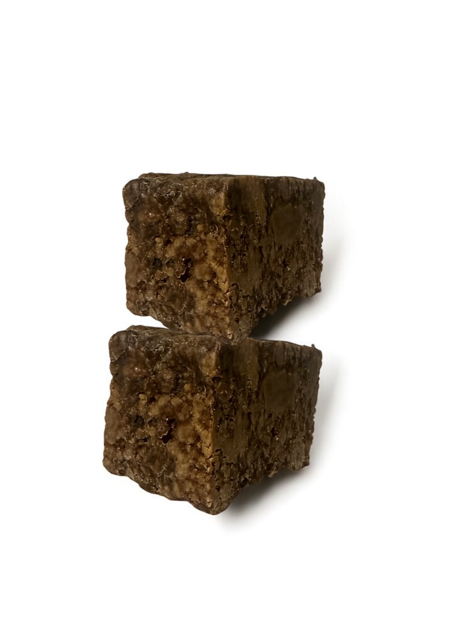 Two African black soap stacked on a white background