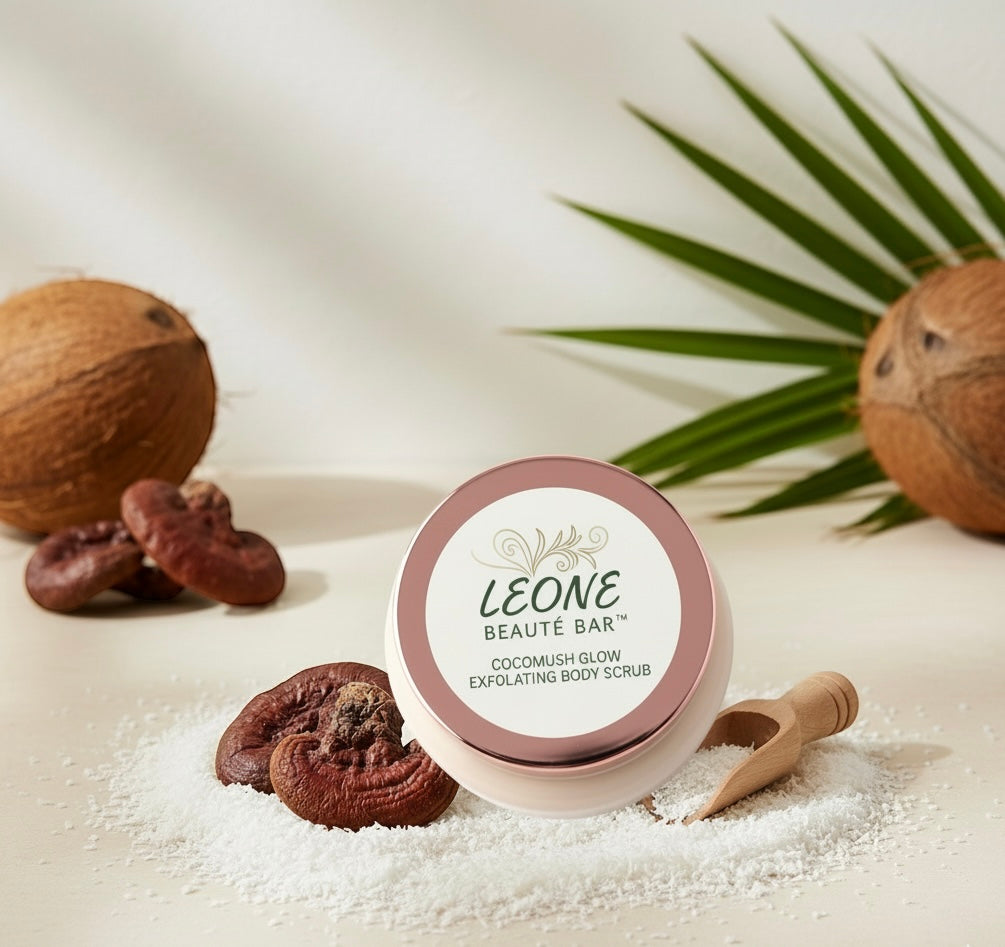LEONE BEAUTÓ BAR coconut glow exfoliating body scrub with coconuts and a scoop on a light background